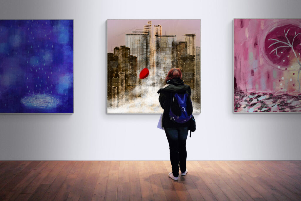 A woman gazes at a large framed canvas artwork titled 'Lost In Time,' displayed prominently in the center of a gallery wall. Flanking it are two equally sized art pieces: 'Never Stop' on the left, featuring vibrant brushstrokes of resilience, and 'Pink Wabi Sabi' on the right, embodying the beauty of imperfection. The gallery setting emphasizes the emotional depth and storytelling of each piece.