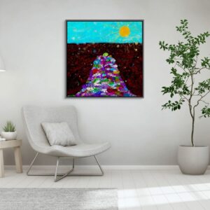 A big canvas print in a frame is on the white wall behind the comfy gray chair next to the tall plant.