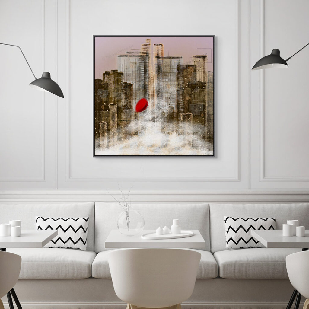 A big canvas print in a frame is on the wall behind a table and sofa in a cafe.