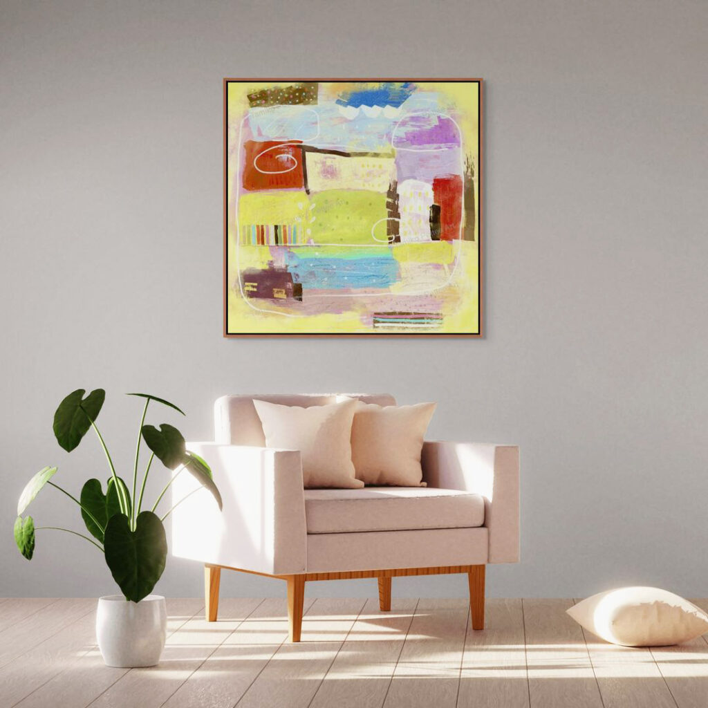 A big canvas print in a frame is on the wall behind a luxury beige fabric chair.