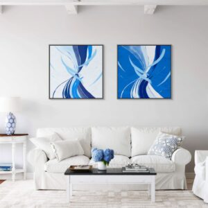 Cobalt Breeze (Diptych) are on the white wall behind the white modern couch in the fancy livingroom.