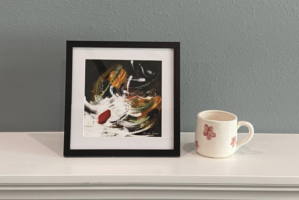 A 6x6 art print is in the matted black frame.